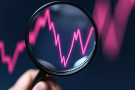hand-holding-magnifying-glass-red-graph-line-symbolizes-analysis-high-yield-savings-stock-market-performance